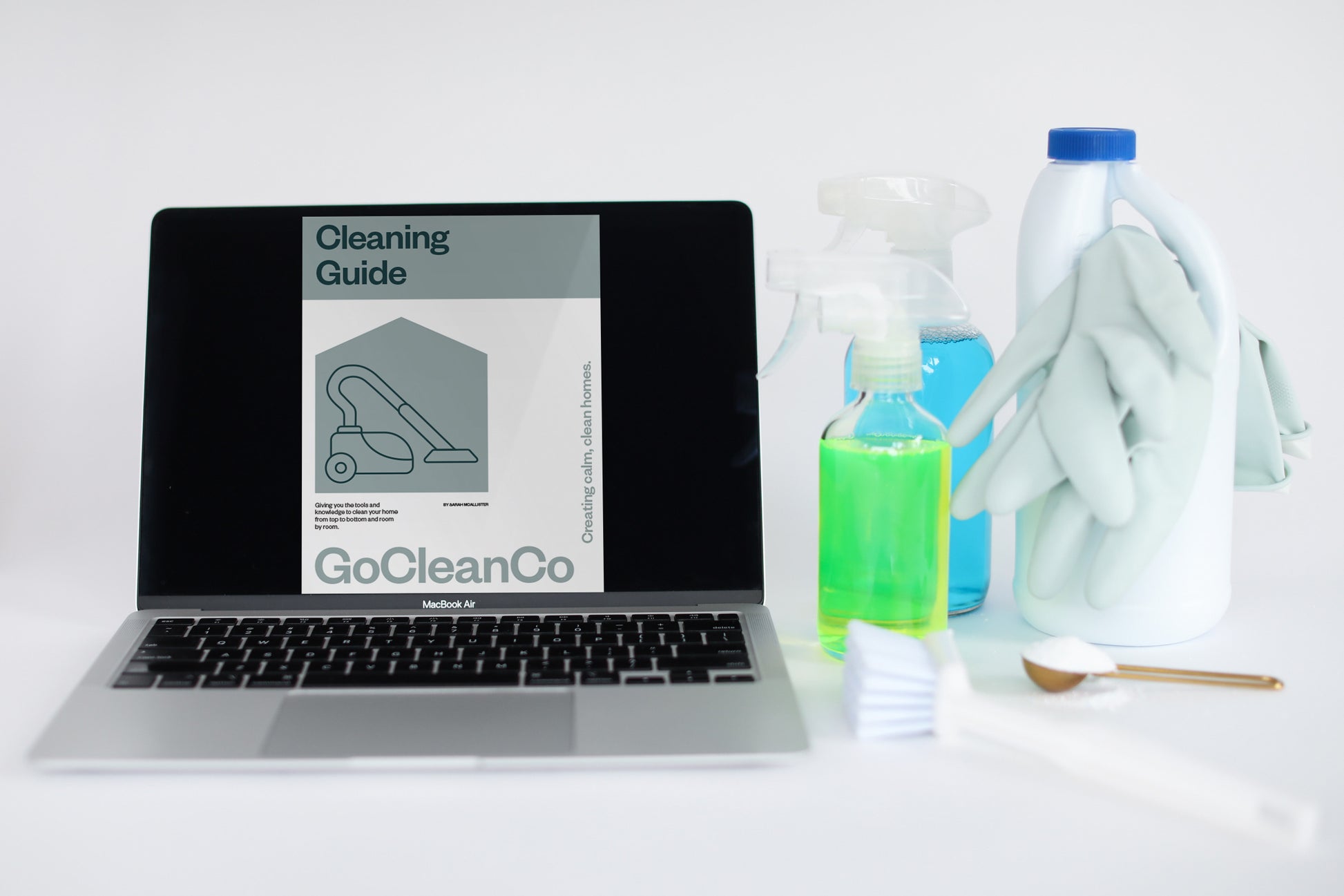 The GoCleanCo Cleaning Guide is displayed on a laptop next to cleaning products.