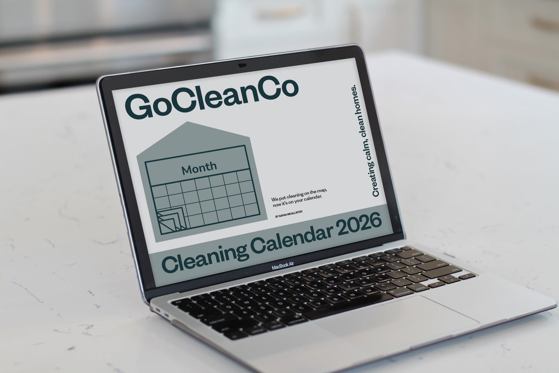 Laptop displaying a cleaning calendar with 'GoCleanCo' branding on a white surface.