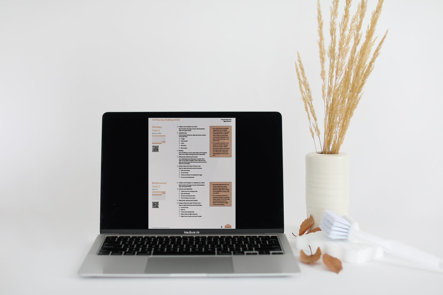 A laptop screen shows a detailed cleaning checklist for the "Fall Cleaning Challenge 2025," specifically for the kitchen and bathroom.