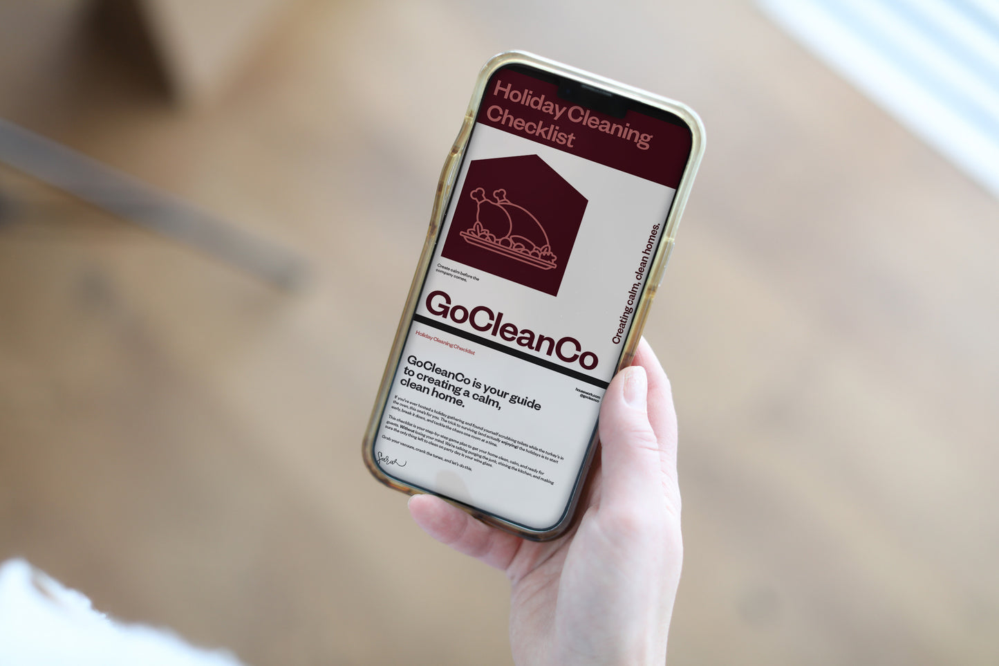 Person holding a smartphone displaying a Holiday cleaning checklist.