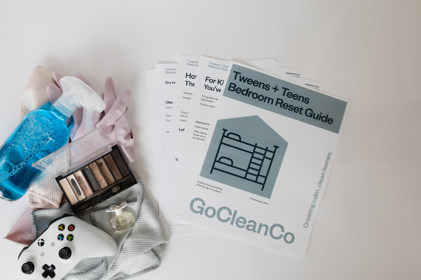 Cleaning supplies and a 'GoCleanCo' Tweens + Teens Bedroom Reset guide on a light surface